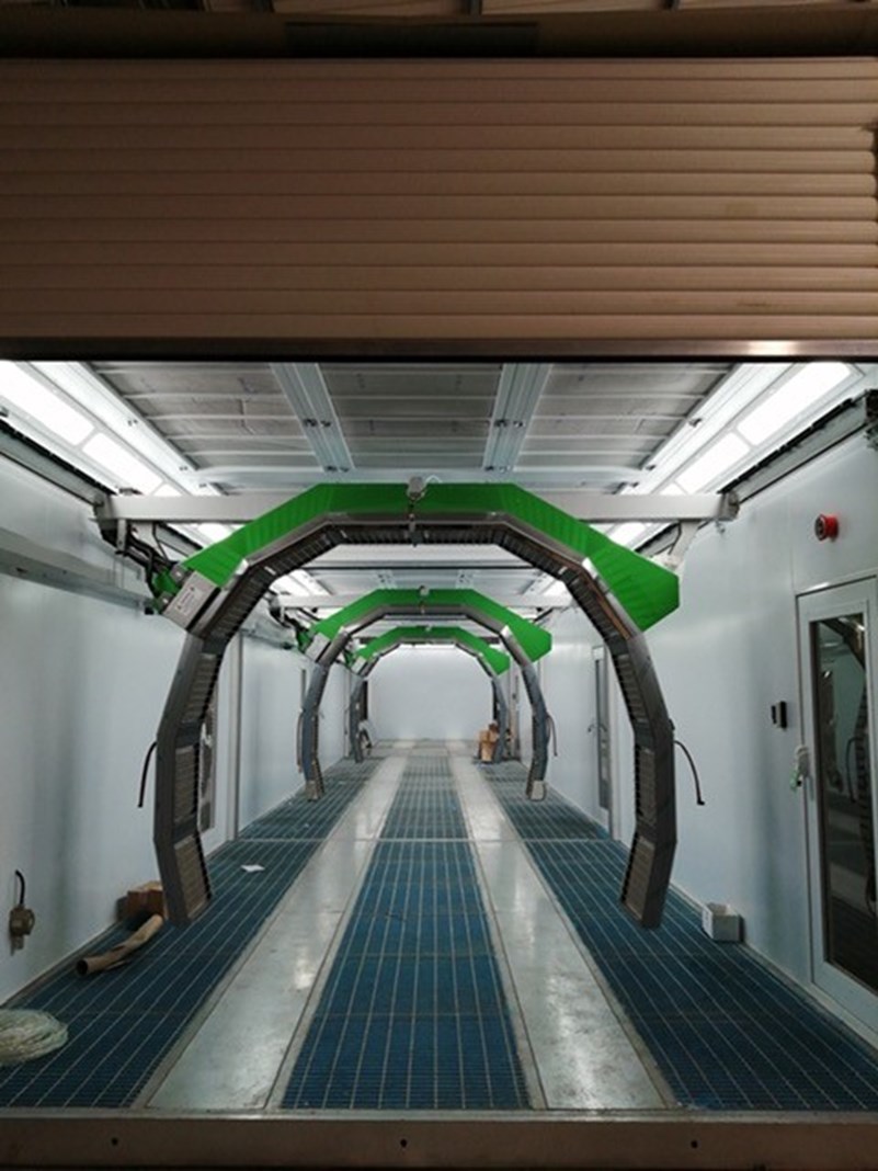 Greentech curing robots in a spray booth